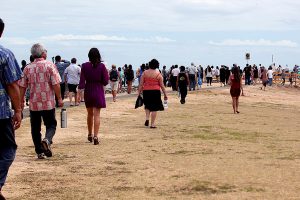 Loved ones gather at the Waikiki end of Magic Island to watch the scattering of cremains offshore.